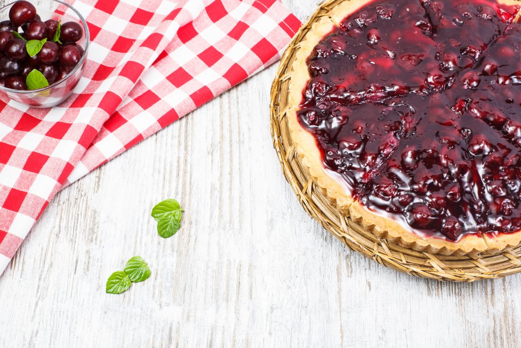 Cherry pie with cherries on top. Copy space composition