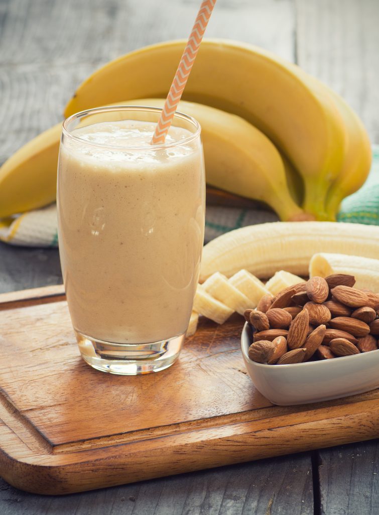 Fresh made Banana smoothie on wooden background